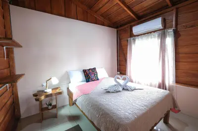 a small bedroom with a bed and a window at Cabaña ITZE in Fortuna