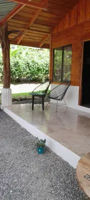 a porch with a bench and a table at Cabaña ITZE in Fortuna