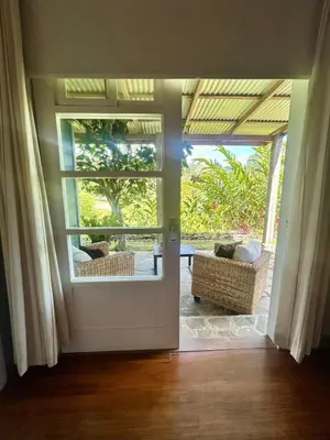 an open door to a living room with a view at Casa Hacienda La Esperanza in Turrialba