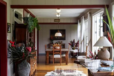 a living room with a table and some plants at Casa Hacienda La Esperanza in Turrialba