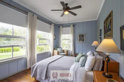 a bedroom with a bed and a ceiling fan at Casa Hacienda La Esperanza in Turrialba