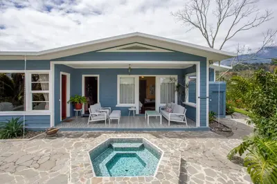 a blue house with a pool on a patio at Casa Hacienda La Esperanza in Turrialba