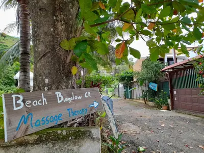 a sign for the beach burleigh c massey harvey harbor at Jaco Surf Beachbungalow in Jacó