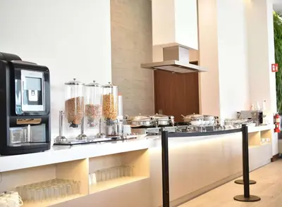 a kitchen with a counter with many pots and pans at Hilton Garden Inn Santa Ana, San Jose in San José