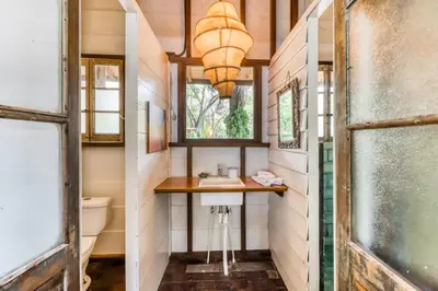 a bathroom with a sink and a toilet at El Ballenato de Bahia in Uvita