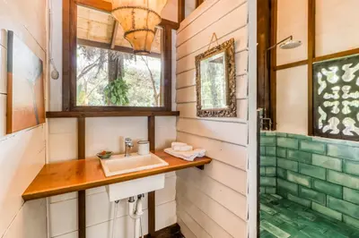 a bathroom with a sink and a shower at El Ballenato de Bahia in Uvita