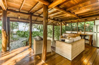 an outdoor living room with couches and a table at El Ballenato de Bahia #2 in Uvita