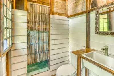a bathroom with a toilet and a sink at El Ballenato de Bahia #2 in Uvita