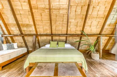 a bedroom with a bed in a bamboo room at El Ballenato de Bahia #2 in Uvita