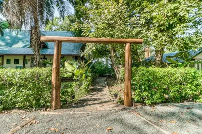 a wooden archway in front of a building at El Ballenato de Bahia #2 in Uvita