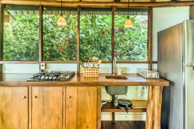 a kitchen with a wooden counter top and a refrigerator at El Ballenato de Bahia #2 in Uvita