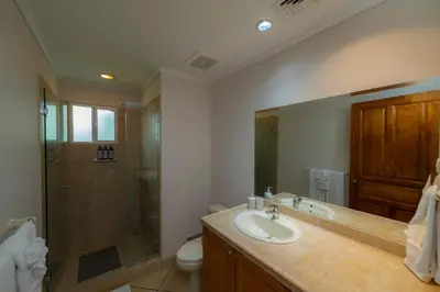 a bathroom with a sink and a shower and a toilet at Del Mar 3C 3 bdr Ocean View in Los Suenos in Herradura