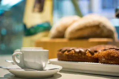 a table with a cup of coffee and a plate of bread at Del Mar 3C 3 bdr Ocean View in Los Suenos in Herradura