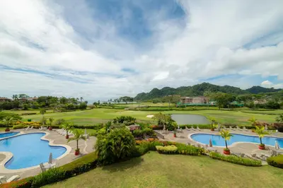 an aerial view of a resort with two pools at Del Mar 3C 3 bdr Ocean View in Los Suenos in Herradura