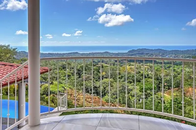 a balcony with a view of the ocean at Stunning Casa de la Roca House with Infinity Pool! in Ojochal