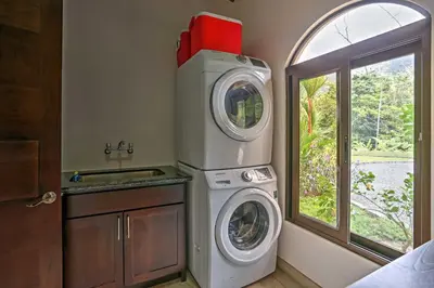 a laundry room with a washing machine and a window at Stunning Casa de la Roca House with Infinity Pool! in Ojochal