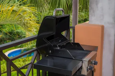 a black grill sitting on top of a fence at Veranda 1C 3 bdr Golf Course View in Los Suenos in Herradura