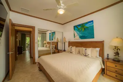 a bedroom with a bed and a ceiling fan at Veranda 1C 3 bdr Golf Course View in Los Suenos in Herradura