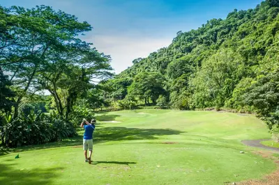 a man standing on a golf course looking at a green at Veranda 1C 3 bdr Golf Course View in Los Suenos in Herradura