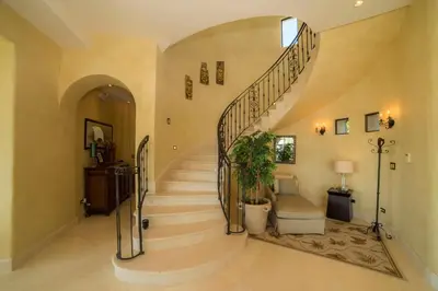 a large hallway with a spiral staircase in a house at Puesta del Sol 5 bdrs ocean view in Los Suenos in Herradura