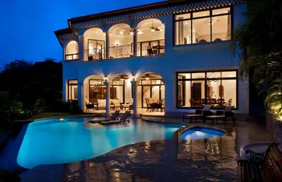 a house with a swimming pool in front of it at Puesta del Sol 5 bdrs ocean view in Los Suenos in Herradura
