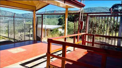 a balcony of a house with a view of the mountains at Casa con vista a valle de Dota y zona cafetalera in Santa María
