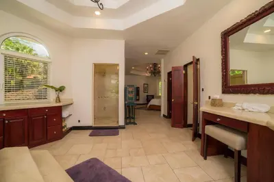 a bathroom with a sink and a mirror in a room at Harmon Estate 6 bdrs private pool in Los Suenos in Herradura