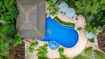 an overhead view of a swimming pool at a resort at Harmon Estate 6 bdrs private pool in Los Suenos in Herradura