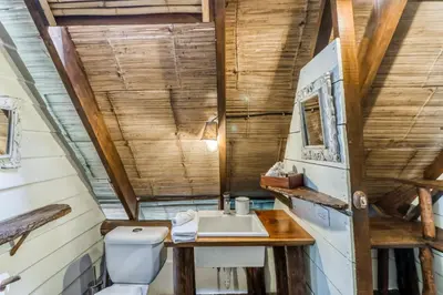 a bathroom with a sink and a toilet at El Ballenato de Bahia Whole House in Uvita