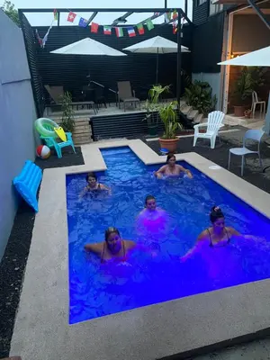 a group of people swimming in a swimming pool at Hotel Pacuare Turrialba in Turrialba