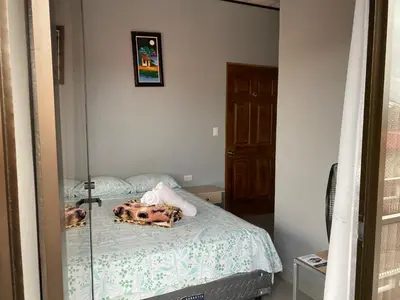 a bedroom with a bed with a mirror on it at Hotel Pacuare Turrialba in Turrialba