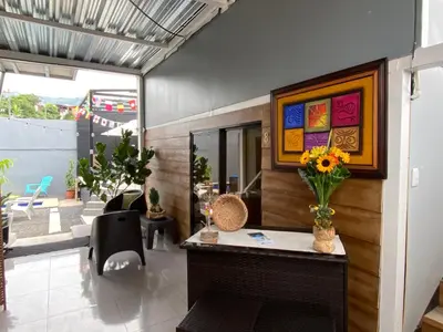 a room with a desk with a vase of flowers on it at Hotel Pacuare Turrialba in Turrialba