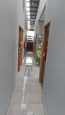 a hallway of a building with a rug on the floor at Hotel Pacuare Turrialba in Turrialba