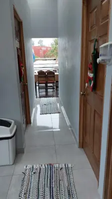 a hallway with a door and a rug on the floor at Hotel Pacuare Turrialba in Turrialba