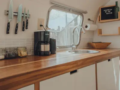 a kitchen counter with a sink and a window at Airstream by the Sea in Nosara