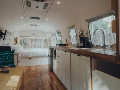 an rv kitchen with a sink and a bed at Airstream by the Sea in Nosara