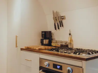 a kitchen counter with a stove top oven in a kitchen at Airstream by the Sea in Nosara