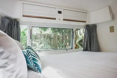 a bedroom with a bed and a large window at Airstream by the Sea in Nosara