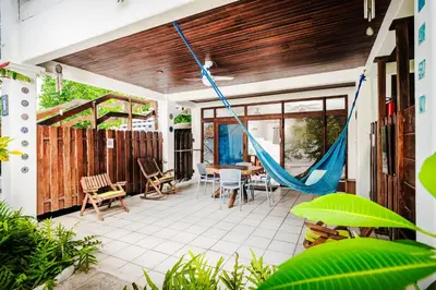 a patio with a hammock on a house at Casa Sueca Hotel - At the Beach in Tamarindo