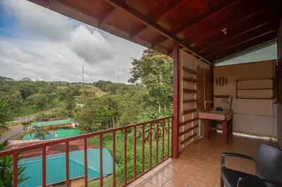 a balcony with a view of a pool at Beautiful Casa Aire near Lake Arenal in Nuevo Arenal - Casas Airelibre in Nuevo Arenal