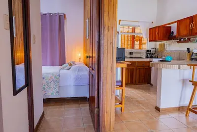 a kitchen with a bedroom and a bed in a room at Beautiful Casa Aire near Lake Arenal in Nuevo Arenal - Casas Airelibre in Nuevo Arenal