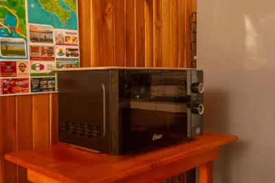 a microwave sitting on top of a wooden table at Beautiful Casa Aire near Lake Arenal in Nuevo Arenal - Casas Airelibre in Nuevo Arenal