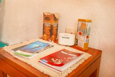 a table with books and other items on it at Beautiful Casa Aire near Lake Arenal in Nuevo Arenal - Casas Airelibre in Nuevo Arenal
