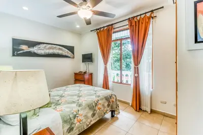 a bedroom with a bed and a window at La Paloma Blanca D2 in Jacó