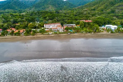 an aerial view of a beach with buildings and houses at La Paloma Blanca D2 in Jacó