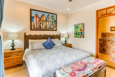 a bedroom with a bed and two lamps at La Paloma Blanca D2 in Jacó