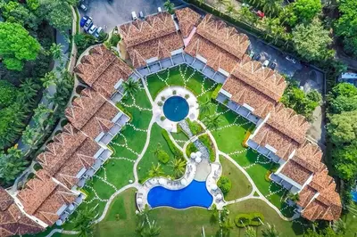 an aerial view of a resort with a pool at Spacious Open-Concept Condo with Stylish Design, Direct Beach Access & Resort-Style Amenities in Playa Flamingo