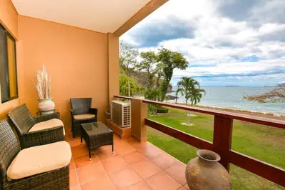 a balcony with a view of the ocean at Elegant 3BR Beachfront Condo with Spacious Interior, Ocean-View Terrace & Direct Access to Playa Flamingo in Playa Flamingo
