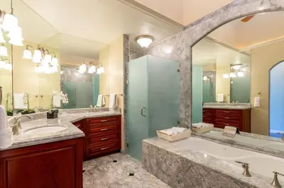 a bathroom with two sinks and a large mirror at Modern Oceanfront Condo with a Chic Coastal Design, Resort-Style Amenities, and Direct Beach Access in Playa Flamingo