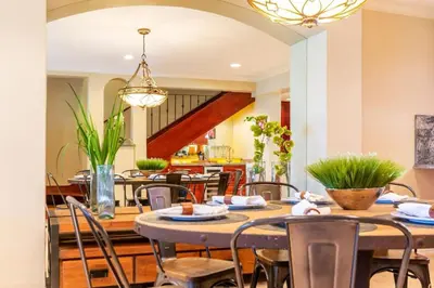 a dining room with a table and chairs at Modern Oceanfront Condo with a Chic Coastal Design, Resort-Style Amenities, and Direct Beach Access in Playa Flamingo